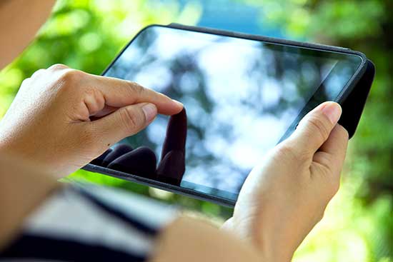 Person touching tablet computer.