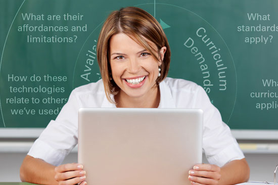 Teacher at desk with her laptop.